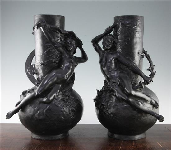 A pair of Art Nouveau black painted metal figural vases, both 18in.